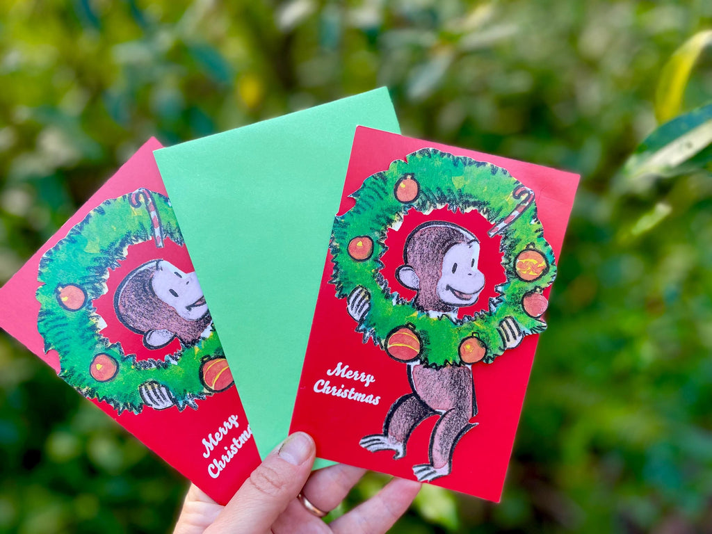 Curious George Christmas Card Boxed Funny Holiday Greeting Card with Monkey and Christmas Wreath It’s the Most Wonderful Time of the Year